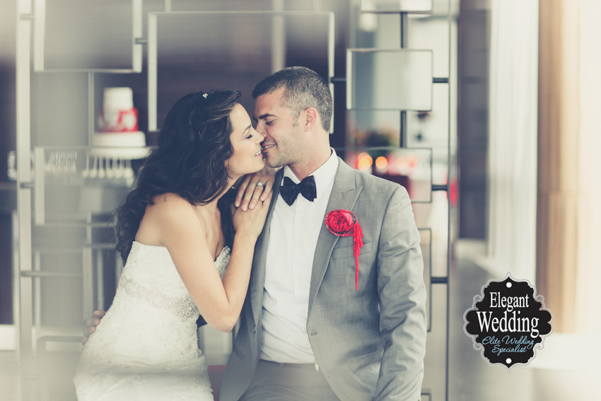 bride kissing by the window