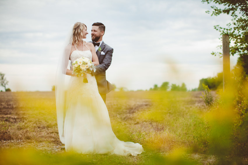 Bride and groom in a field