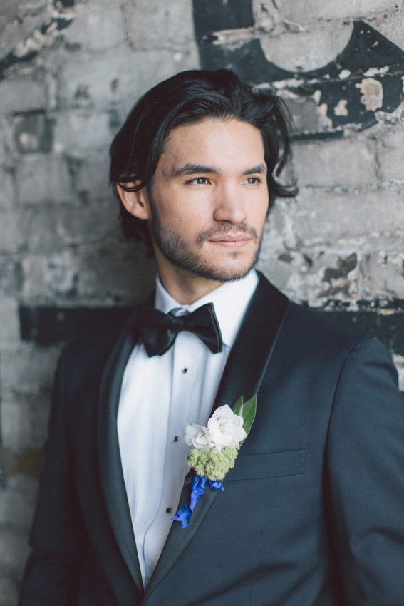 groom's tuxedo with royal blue ribbon on boutonniere