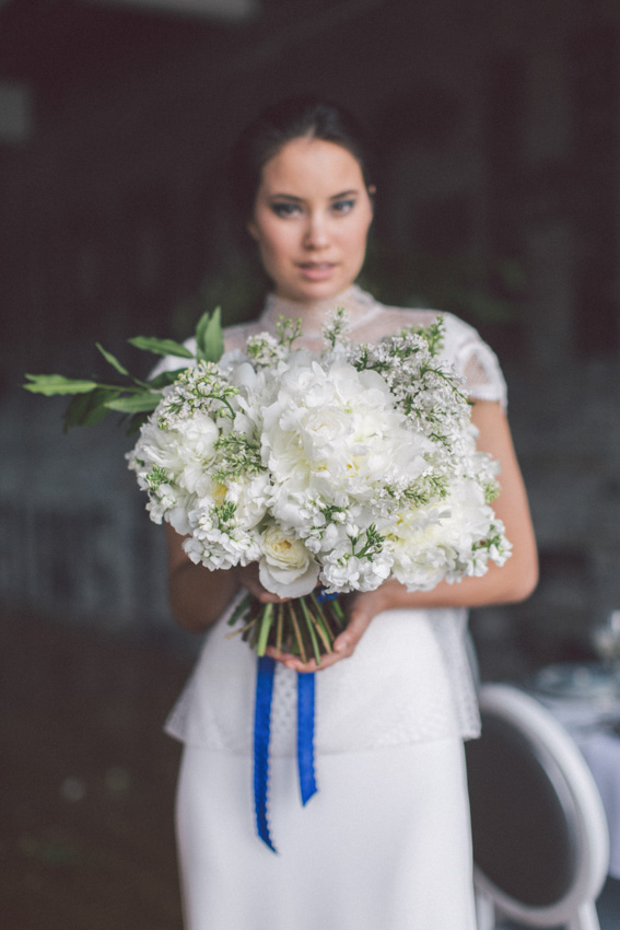 Bride's bouquet with white flowers and blue ribbon