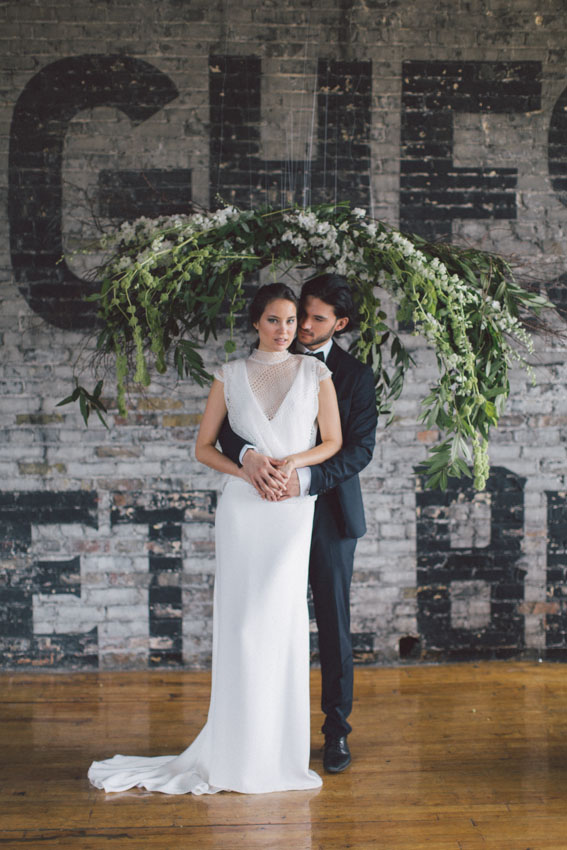 bride and groom with hanging flowers decor