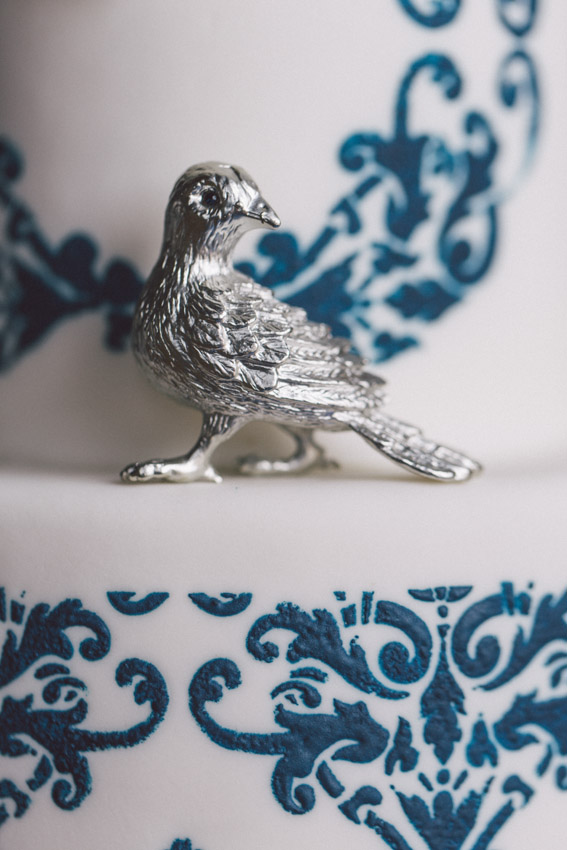 silver bird on blue wedding cake