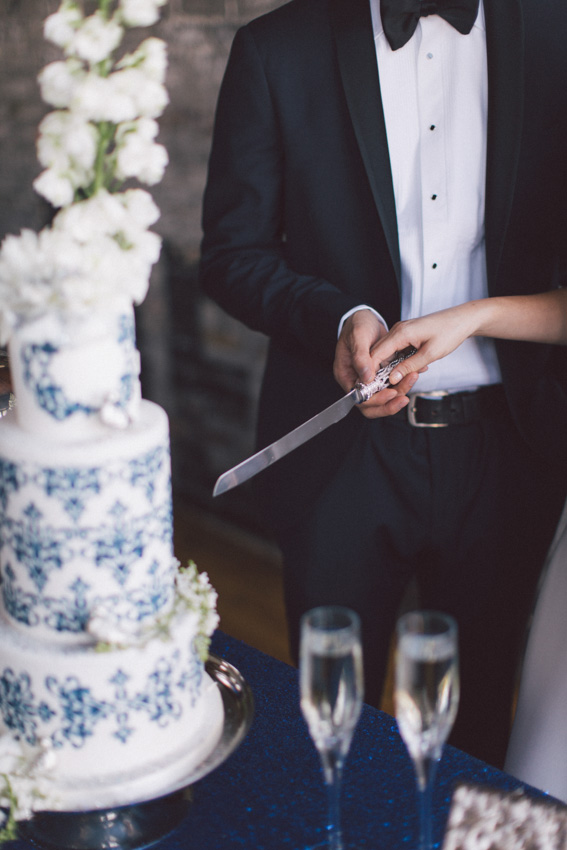 bride and groom cut blue wedding cake