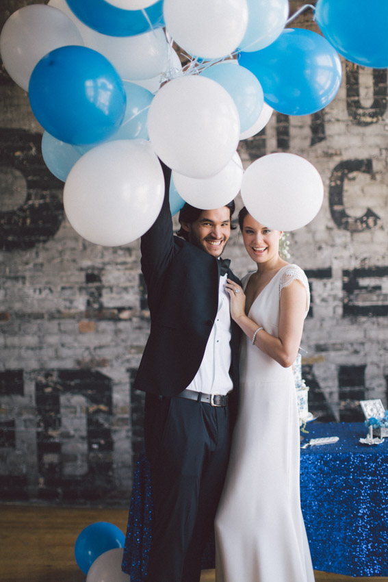 bride and groom with blue and white balloons