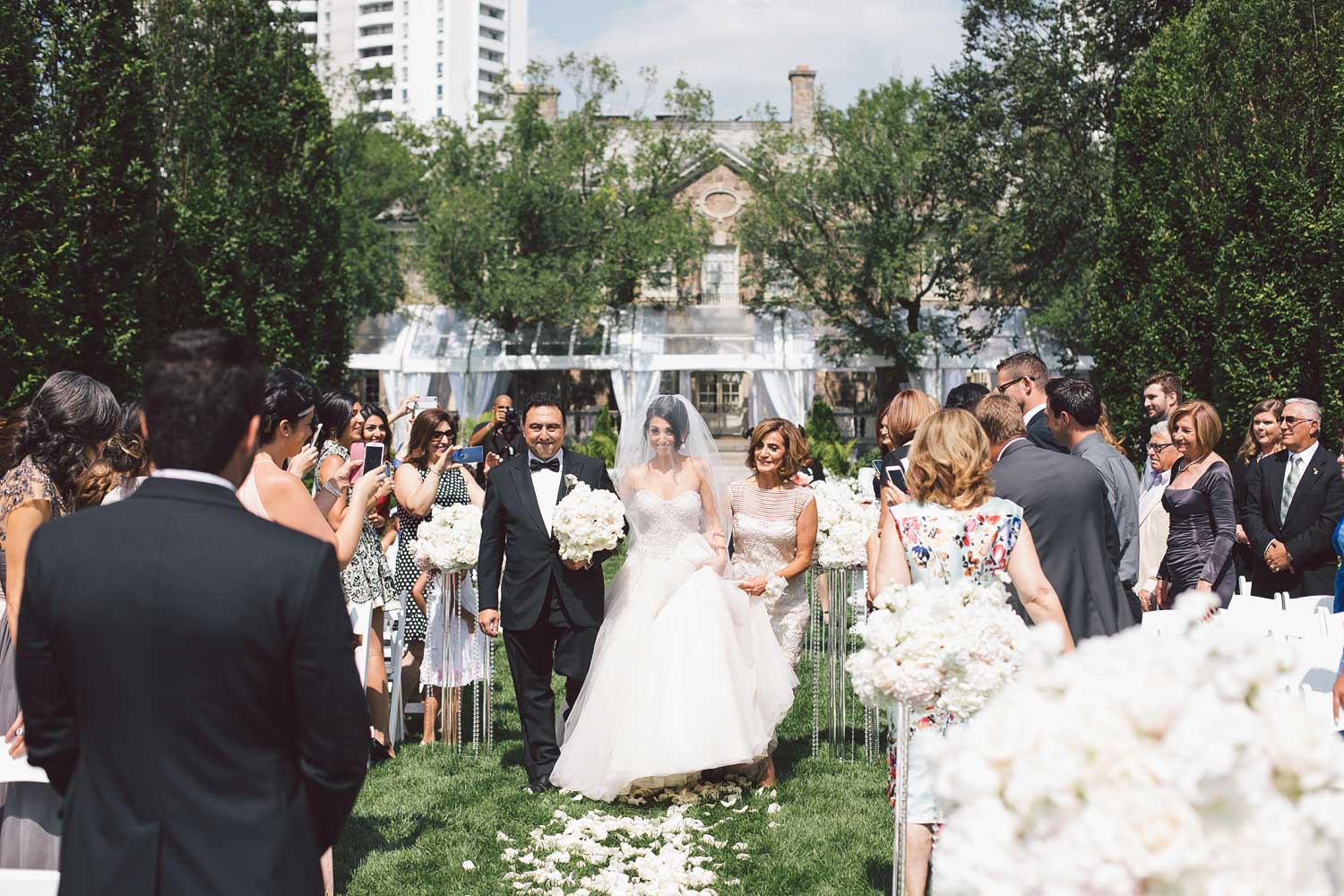bride facing broom at the aisle