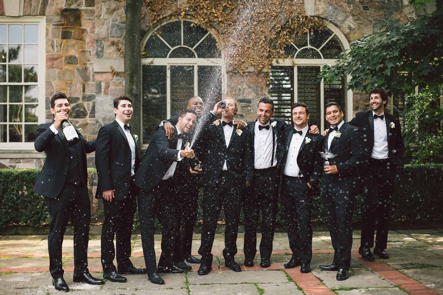 groomsmen opening up champagne