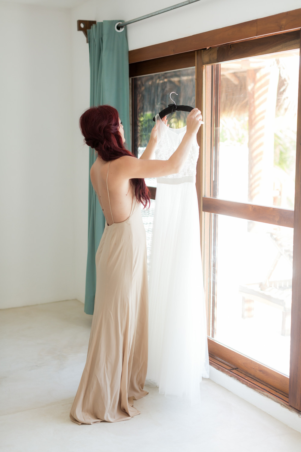bridesmaid helping with wedding dress 