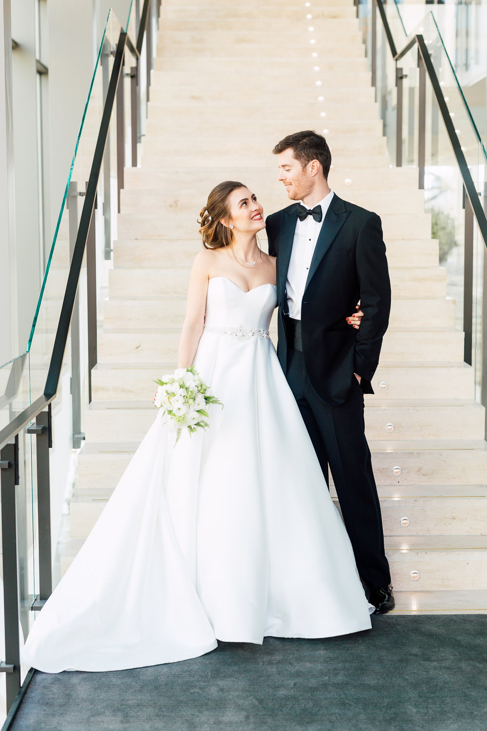 bride and groom by staircase