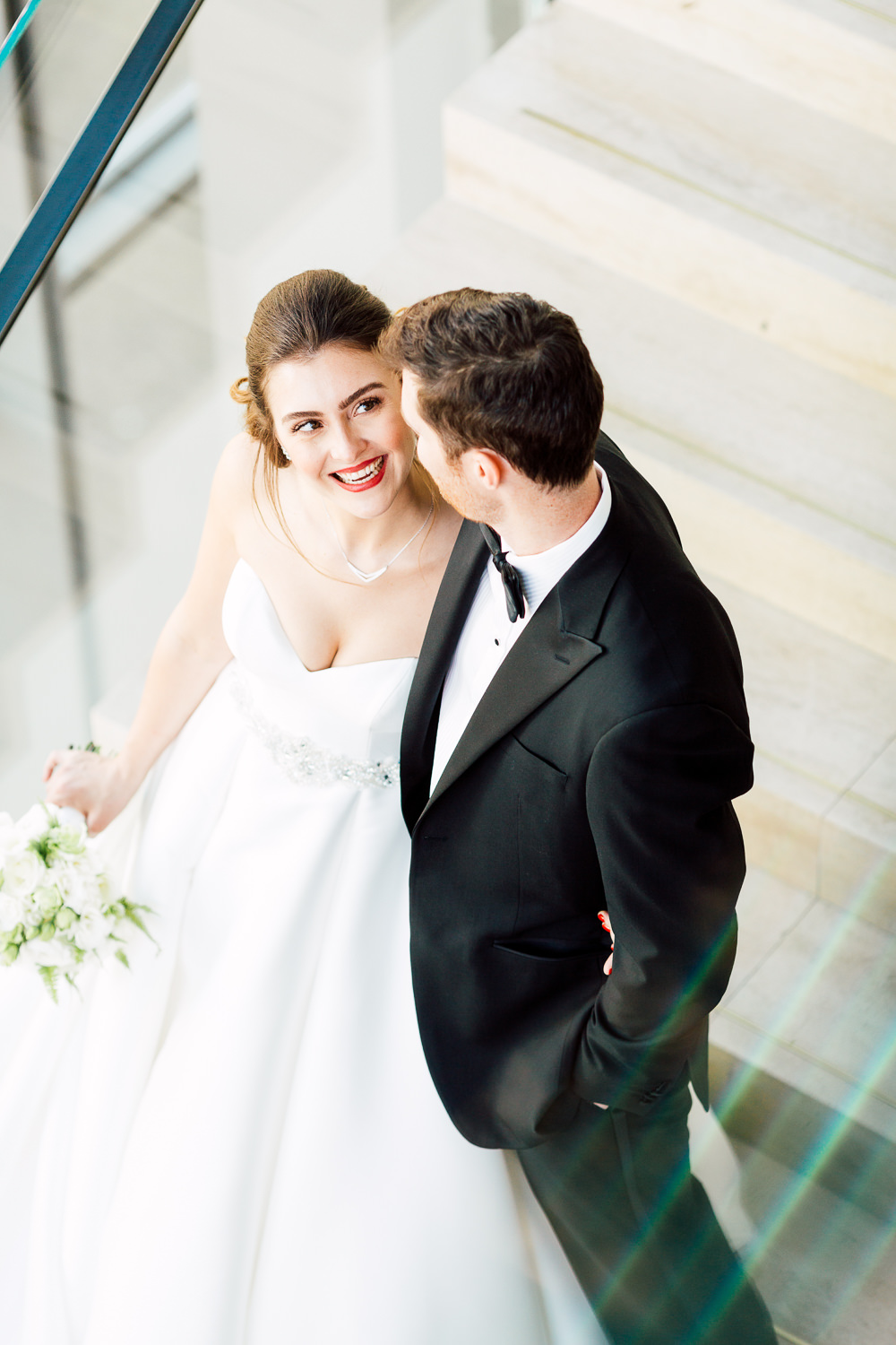 bride and groom by staircase