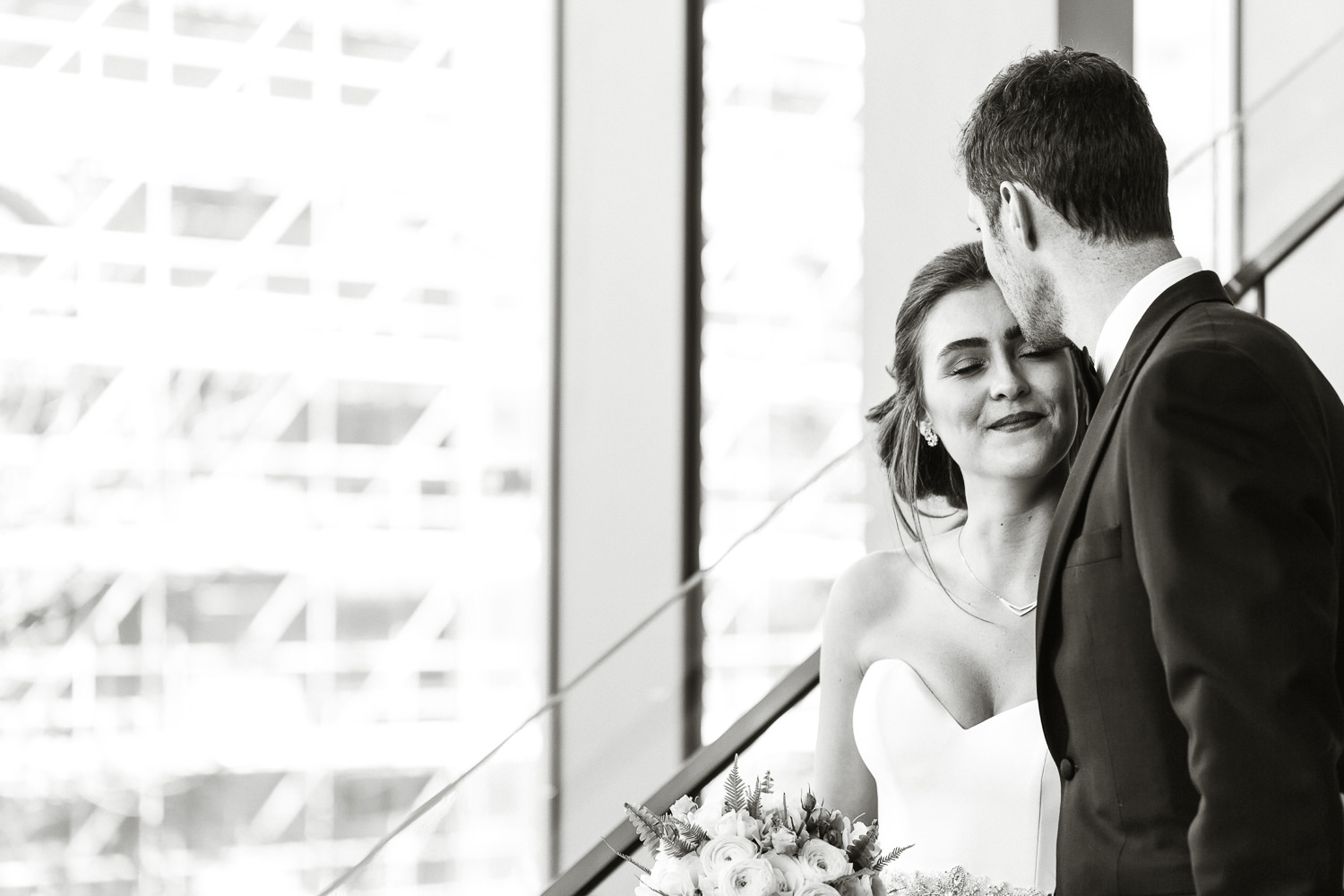 bride and groom by staircase