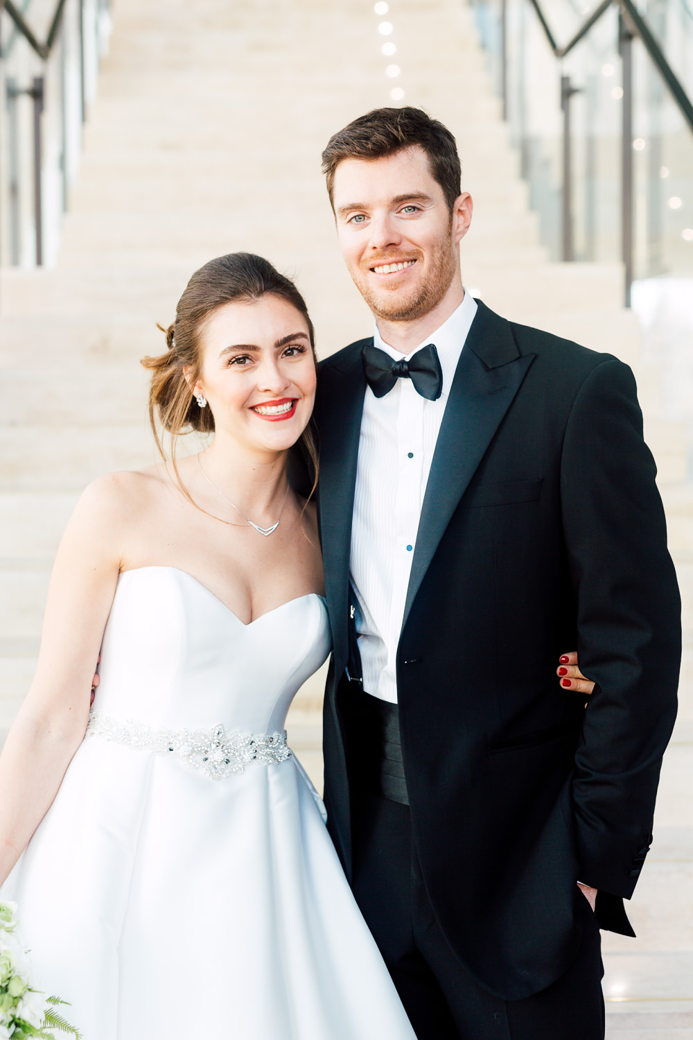 bride and groom by staircase