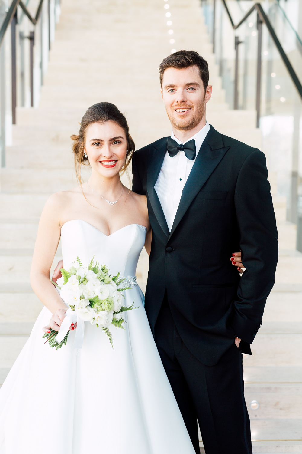 bride and groom by staircase