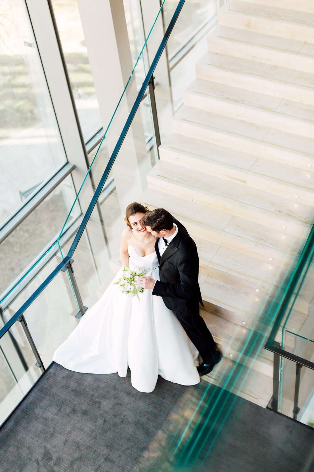 bride and groom by staircase