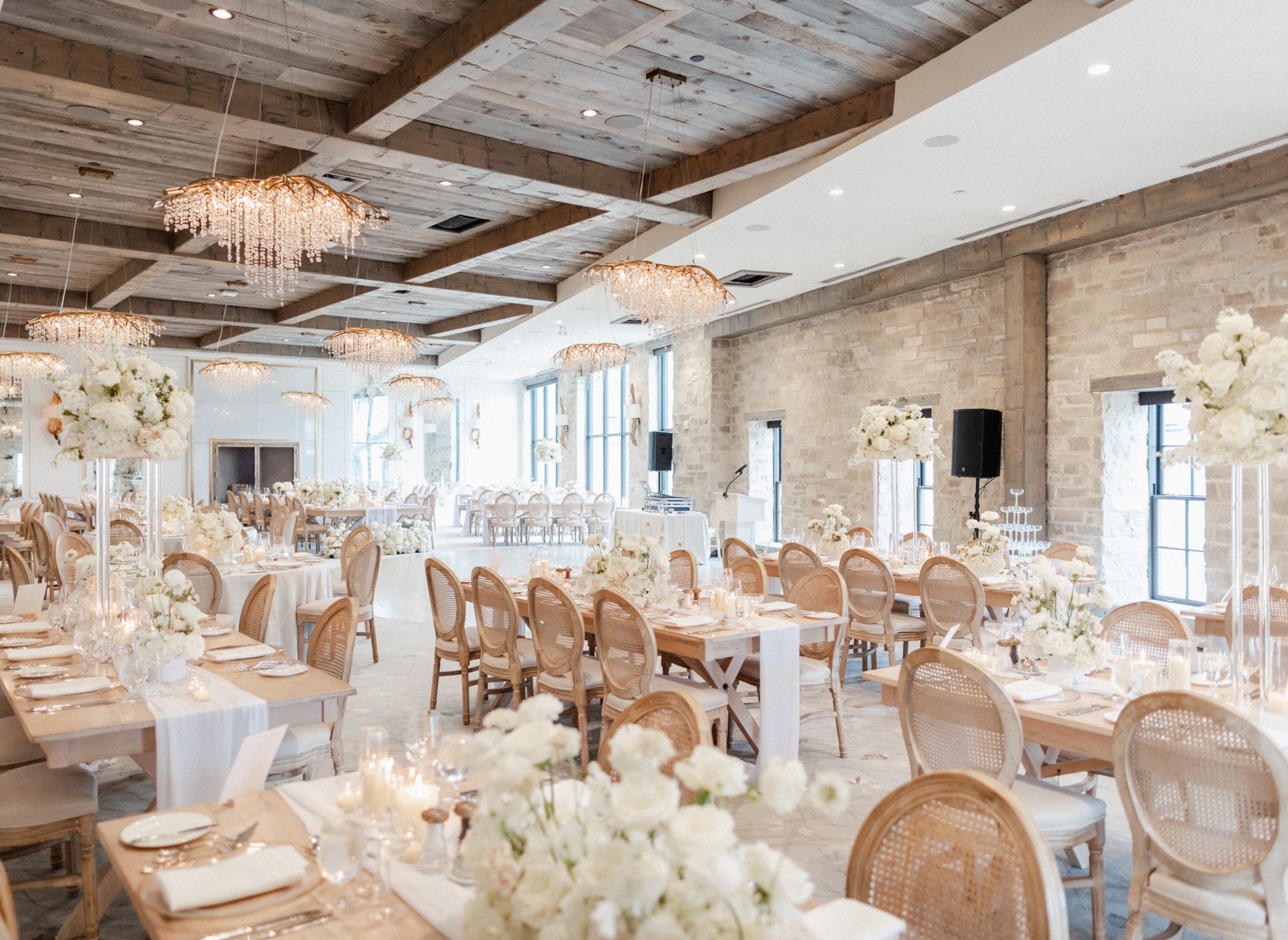 A rustic wedding reception at Elora Mill, adorned with elegant white flowers, creating a charming ambiance.