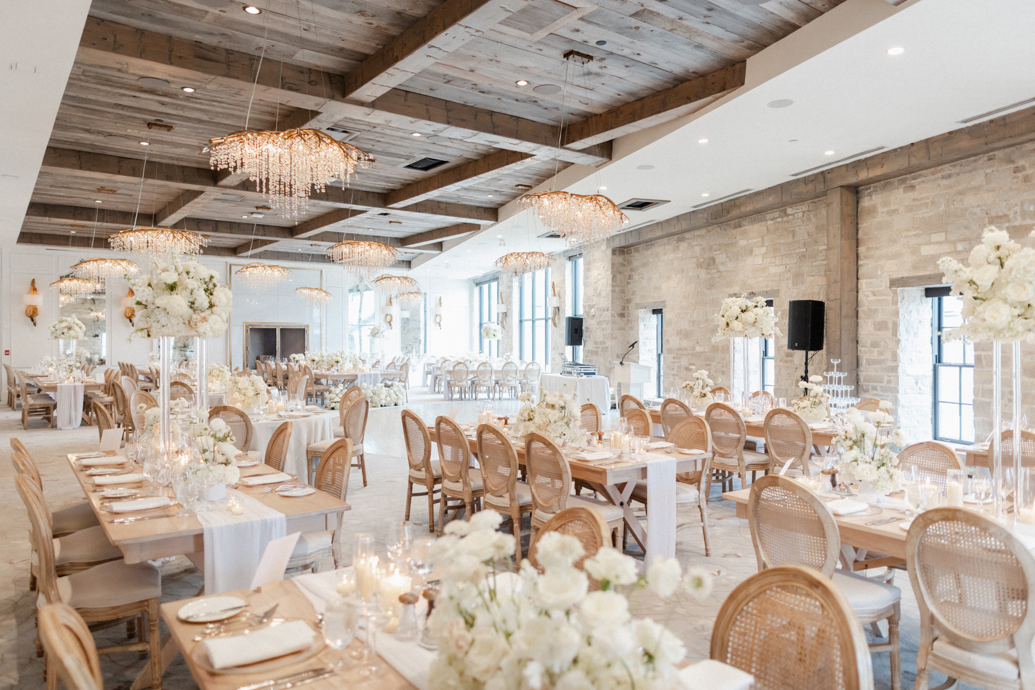 A rustic wedding reception at Elora Mill, adorned with elegant white flowers, creating a charming ambiance.