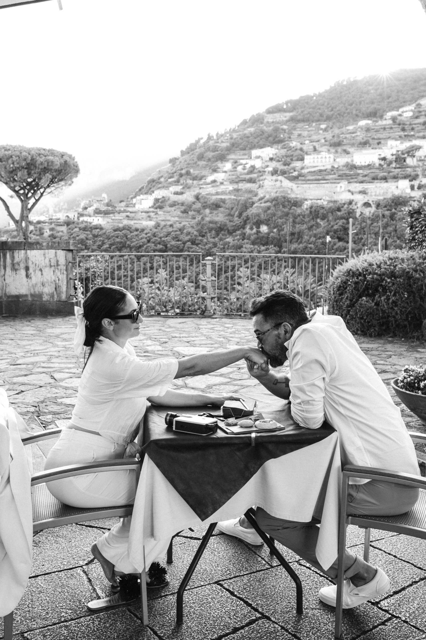 Man kissing fiancés hand at Italy Café