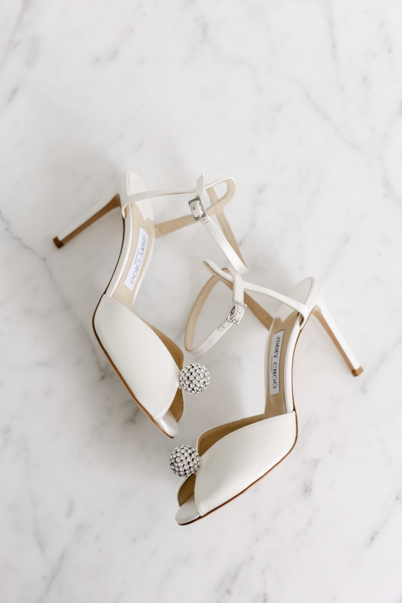 a pair of white high heeled shoes