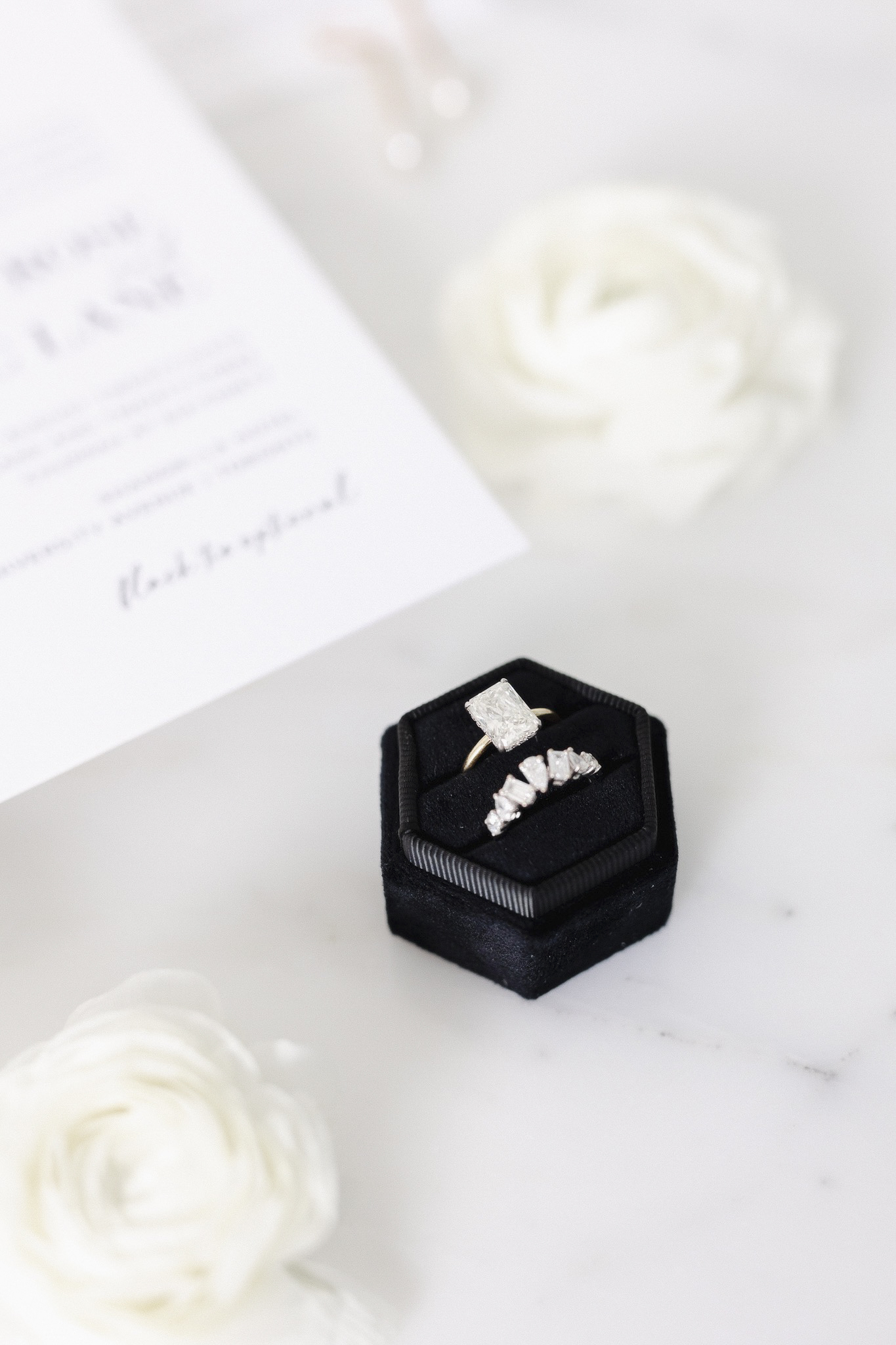 A wedding ring in a black ring box